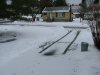Fresh snow on winter driveway and car tire tracks