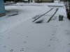Fresh snow on winter driveway and car tire tracks