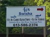 Sign for Air Swisha - fly in canoe and kayak trips - and fishing
