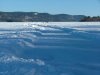 Plowed road on the river leading to the ice fishing huts