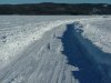 Plowed road on the river leading to the ice fishing huts