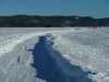 Plowed road on the river leading to the ice fishing huts