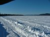 Plowed road on the river leading to the ice fishing huts