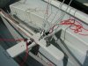 Albacore jib rigging for single handed. The reason for jib cleats near the main sheet is that I can release the jib without having to let go of the mainsheet: as letting go of the mainsheet while setting the jib is an easy cause of turtling the boat. Photo is a bit misleading for the mainsheet rigging as the cleats are normally pointing towards the back/stern of the boat when ready to sail.  Port and starboard jib sheets are now different colours (blue and red).  Centerboard has a CL257 Auto-release Racing Mini Clamcleat with dinghy braid, as well as a backup Clamcleat with Shockcord