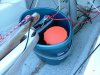 Big bucket with safety gear - all tethered.  Big bucket needed for bailing if Alabcore capsizes. But also needs to be tethered that is does not float or sink away during a capsize.