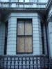 Boarded up windows in the Embassy complex of Shame