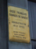 Golden Plaque on a front door of the French Embassy Complex of Shame (FECOS)