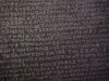 Blurred images of the Greek script on the Rosetta Stone