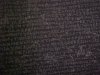 Blurred images of the Greek script on the Rosetta Stone