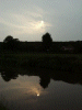 Hazy sun and reflection from the canal