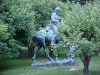 Statue of Abraham Lincoln reading a book, on a horse which is chomping grass