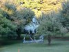 Statue of Abraham Lincoln reading a book, on a horse which is chomping grass