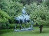 Statue of Abraham Lincoln reading a book, on a horse which is chomping grass