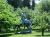 Statue of Abraham Lincoln reading a book, on a horse which is chomping grass