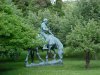 Statue of Abraham Lincoln reading a book, on a horse which is chomping grass