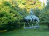 Statue of Abraham Lincoln reading a book, on a horse which is chomping grass
