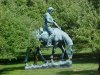 Statue of Abraham Lincoln, reading a book on a Horse munching grass