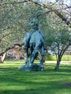 Statue of Abraham Lincoln, reading a book on a Horse munching grass