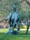 Statue of Abraham Lincoln, reading a book on a Horse munching grass